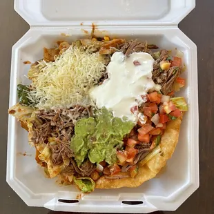 a plate of food in a styrofoam container