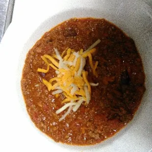 a bowl of chili and cheese