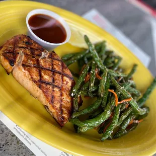 BBQ Salmon with double side of green beans with sauce on the side.