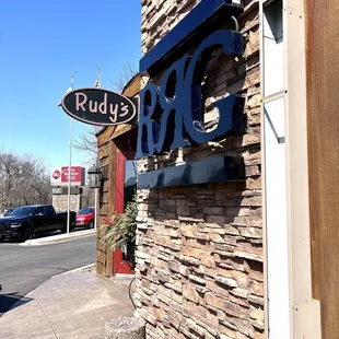a brick building with a sign on it