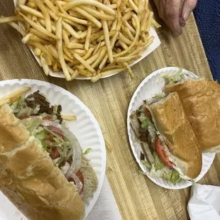 Classic Rudy's cheese steaks and french fries.