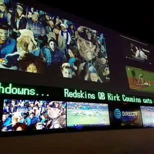 a crowd of people watching televisions