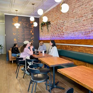 people sitting at tables in a cafe