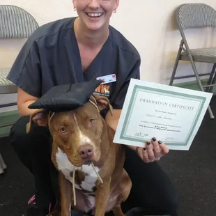More graduation photos of students and pups