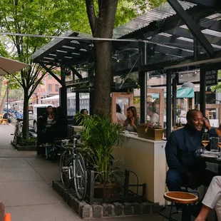 a group of people sitting outside a restaurant