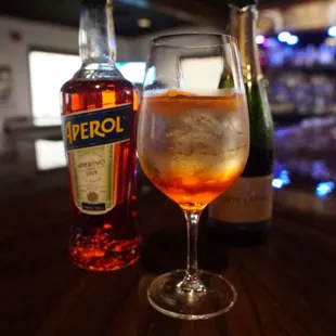 a glass of wine and a bottle of liquor
