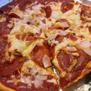 Pepperoni and onions on a gluten free crust