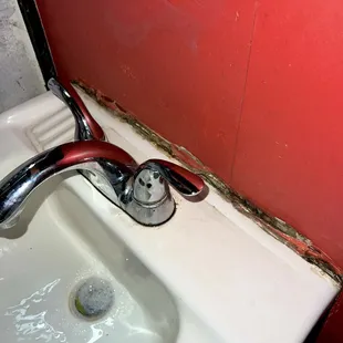 sink holding on for dear life (bathroom)