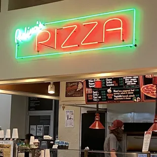 a neon sign above the counter