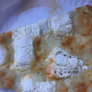 a slice of pizza on a paper plate