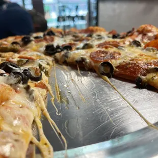 a pizza with olives and cheese