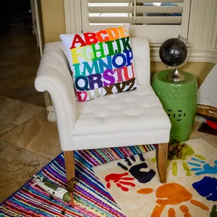 Create an inviting child&apos;s room with a bright colored rug and accessories.