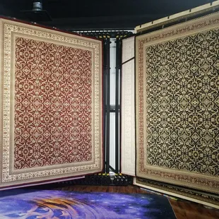 a room with a carpet and a rug on the floor
