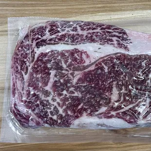 a piece of beef wrapped in plastic