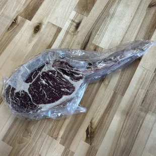 a piece of steak wrapped in plastic