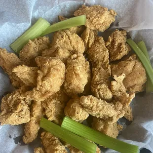 a basket of fried chicken and celery