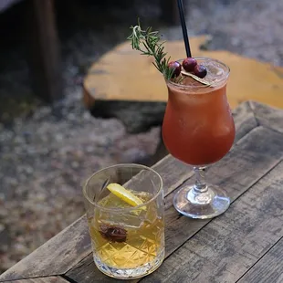 two cocktails on a wooden table