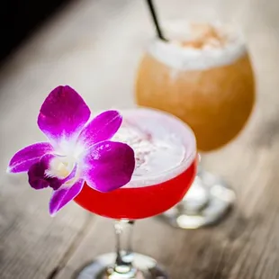 two cocktails on a wooden table