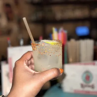 a person holding a drink with a straw