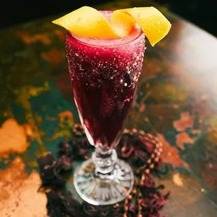 a glass of fruit juice on a table