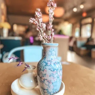 a blue and white vase with flowers in it