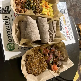 top: four veggie sides dish
 middle: injera
 bottom: steak tibs with lentils