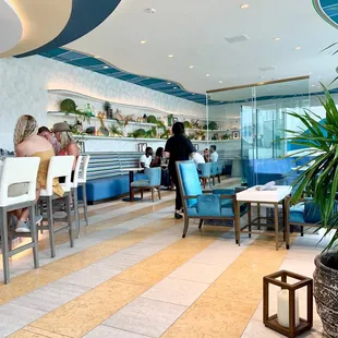 people sitting at tables in a restaurant