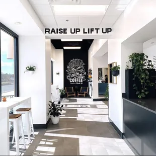 a coffee shop with a sign that says raise up lift up