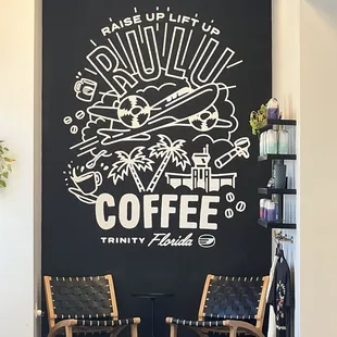 two chairs and a coffee sign