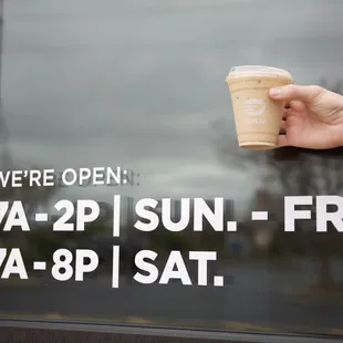 a hand holding a cup of coffee