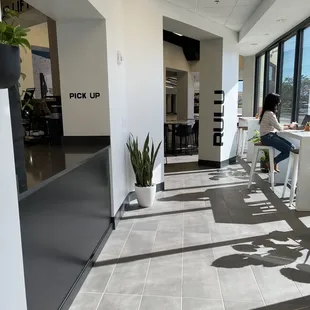 a woman sitting at a table in a coffee shop