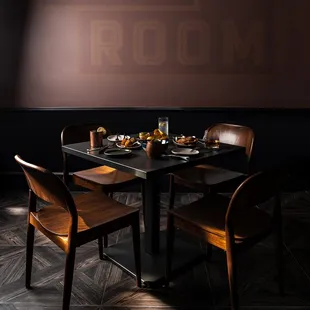 a table and chairs in a dimly lit room