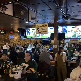 a large group of people sitting at a bar