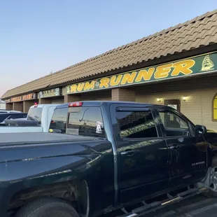 a pickup truck parked in front of a restaurant