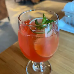 a glass of watermelon drink on a table