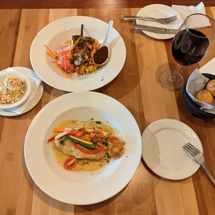 plates of food and a glass of wine