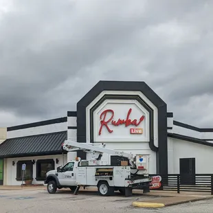 a truck parked in front of a restaurant