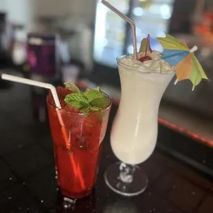 two cocktails on a bar