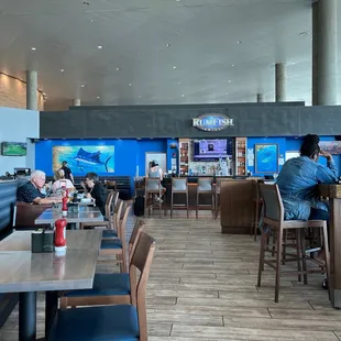 people sitting at tables in a restaurant