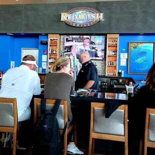 a group of people sitting at a bar