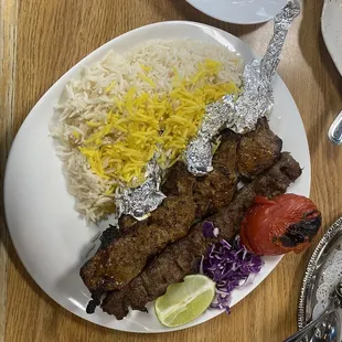 The mout-watering Soltani Platter: one skewer Koobideh plus three skewed lamb shisleeks with rice and a broiled tomato.