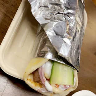 a sandwich wrapped in aluminum foil