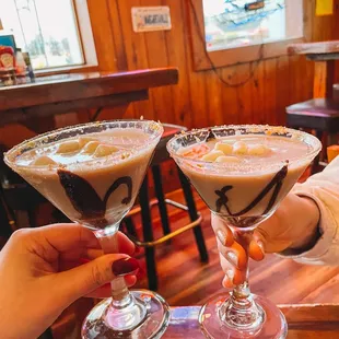 two people toasting drinks at a restaurant