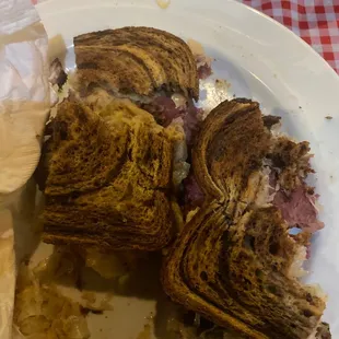 a half eaten sandwich on a plate