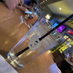 a glass of water with a straw