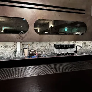 a bar with three mirrors