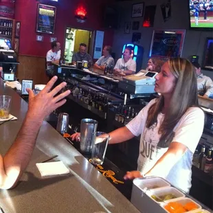 a man and a woman sitting at a bar