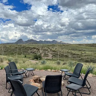 a group of chairs around a fire pit