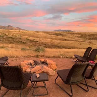 a man standing in front of a fire pit