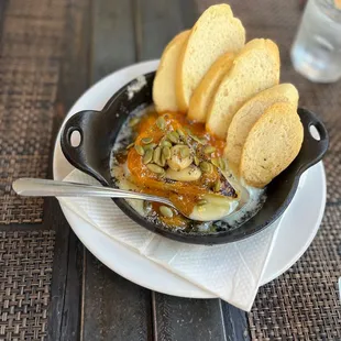 a skillet of food with bread